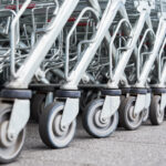 Many empty shopping carts on the shop parking Many empty shopping carts on the shop parking. Row of shopping trolleys for supermarket buyers